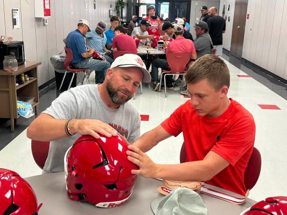 GETTING READY FOR THE GRIDIRON The Silverton Owls football players continued an annual tradition last week, Decals with Dads, as fathers and sons came together to get the team’s helmets ready for the new season. MORE SPOTLIGHT PHOTOS, PAGE 4 | COURTESY PHOTOS