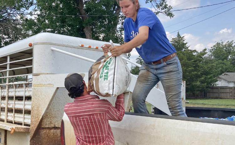 HELPING HAND Volunteers loaded supplies at the school bus barn in Matador, which served as a distribution point for aid and. LIZ ADAMS PHOTO
