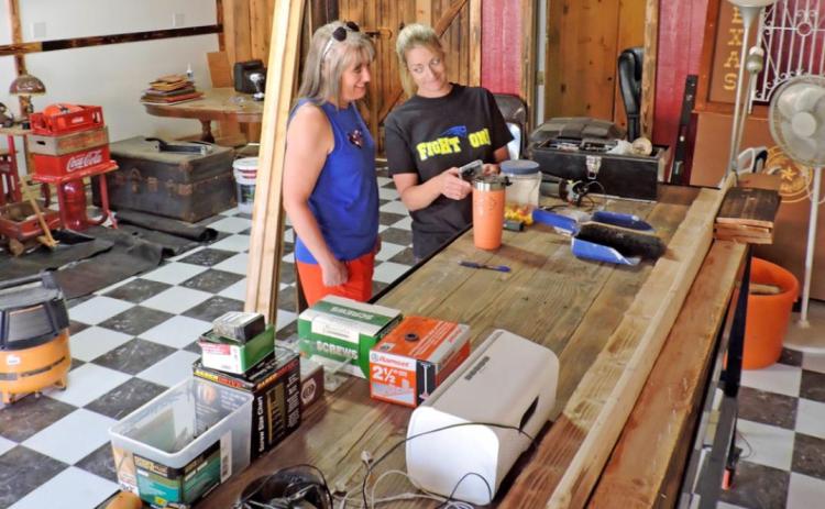 READY TO ROLL In downtown Turkey, Christy Yates and Jamie Plumlee confer at the custom-built counter of Turkey Tracks Coffee Tea &amp; Tees. The two announced Friday on Facebook that they would be open to welcome celebrants of the 50th Bob Wills Day. | HANABA MUNN WELCH; FACEBOOK
