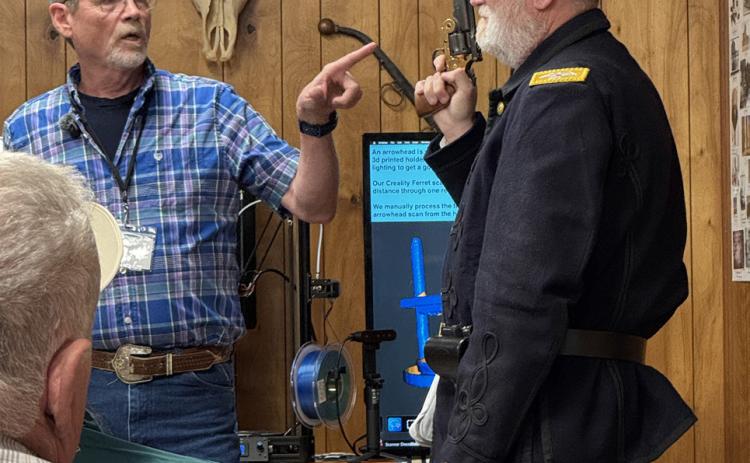 INVESTIGATORTODD SMITH (left) isn’t presuming to give orders to reenactor T. G. Caraway during last Saturday’s Comanchero Rendezvous program—he’s demonstrating the dress and armament of a U.S. army soldier circa 1871, the key focus of his recent archeological explorations. MORE PHOTOS, PAGE 5 | CAPROCK COURIER