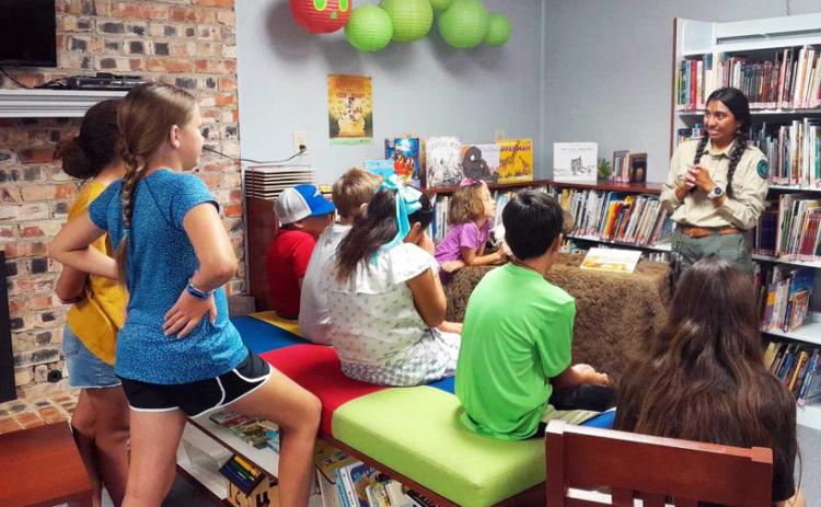 CAPROCKLIBRARYSUMMERREADING JulietteGarzafromCaprock Canyons State Park did a presentation last week at the Caprock Library in Quitaque, teaching youngsters about the bison at park. She read a story to the kids about where, how and why CCSP now has the bison, and brought a bison picture for the kids. Next up, the library will have Texas A&amp;M Forest Service staff for a presentation Wednesday, July 24 at 2 p.m. | COURTESY PHOTO