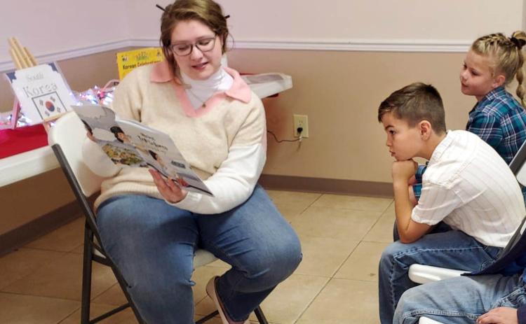 CHRISTMAS AROUND THE WORLD Volunteers at the Caprock Public Library in Quitaque last week continued a special tradition, “Christmas Around the World,” with area schoolchildren. | COURTESY PHOTOS