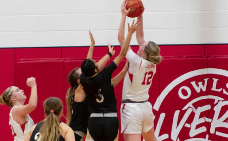 MADDIE FRANCIS CLAIMS A REBOUND under a Lady Tiger goal Friday night in Silverton.