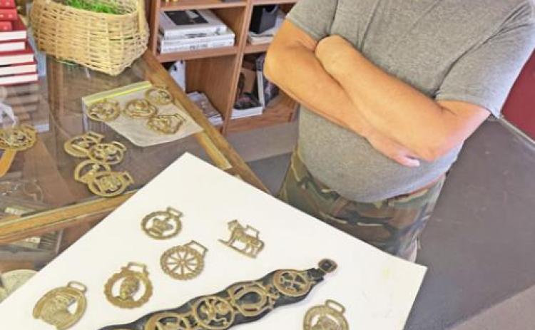 TOP BRASS Jon Shipp, a native of England but now a resident of Spur, explained about horse brasses, including the one celebrating the Silver Jubilee of Queen Elizabeth II. | THE TEXAS SPUR