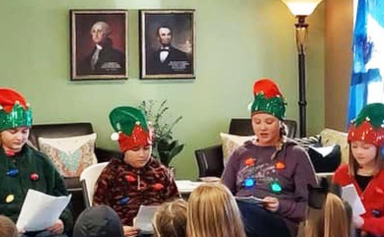 CHRISTMAS AT THE COURTHOUSE Silverton 6th graders read “’Twas the Night Before Christmas” at the library during the courthouse square holiday lighting. | COURTESY PHOTO