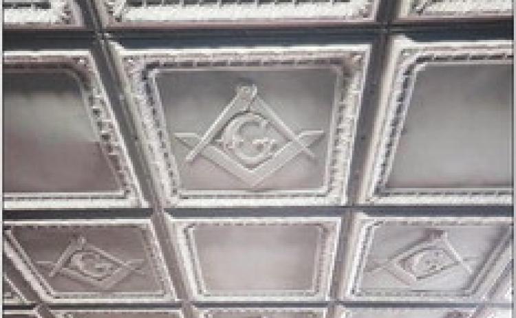 LODGEBRETHREN Metal ceiling tiles in the Lodge room bear the square and compass design.