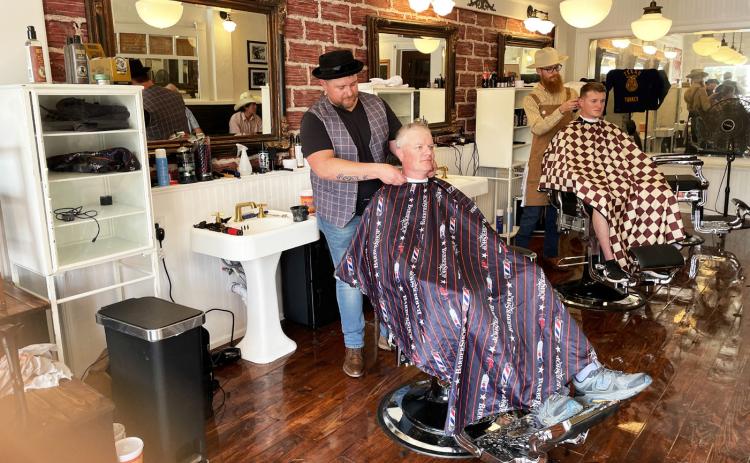 HAIRCUTS AT HAM’S Ham’s Barbershop in downtown Turkey was recognized with a historical marker last week during Bob Wills Day festivities.To celebrate the occasion, haircuts were given in the historic barbershop on Saturday. Renowned musician Bob Wills himself once cut hair at the shop. Preservationist Mike Goolsby, who also recently restored the Phillips 66 gas station inTurkey, undertook the historic restoration project. MORE HIGHLIGHTS ON THE 52nd BOB WILLS DAY, PAGE 10 | CAPROCK COURIER