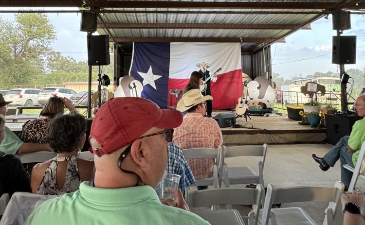 RAINBOW ON THE RANCH Michael Muartin Murphey, featured entertainer at the Texas Press Association dinner June 21, didn’t miss a beat when a rainstorm blew in behind the outdoor stage. | THE TEXAS SPUR
