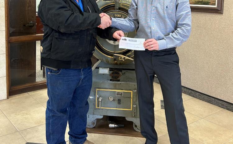 FLOYDADA-BASED FIRST TEXAS NATIONAL BANK recently gave a donation of $10,000 to the Motley County Volunteer Fire Department. Vice president T.K. Farris (right) presented the check to VFD representative Craig Turner. | COURTESY PHOTO