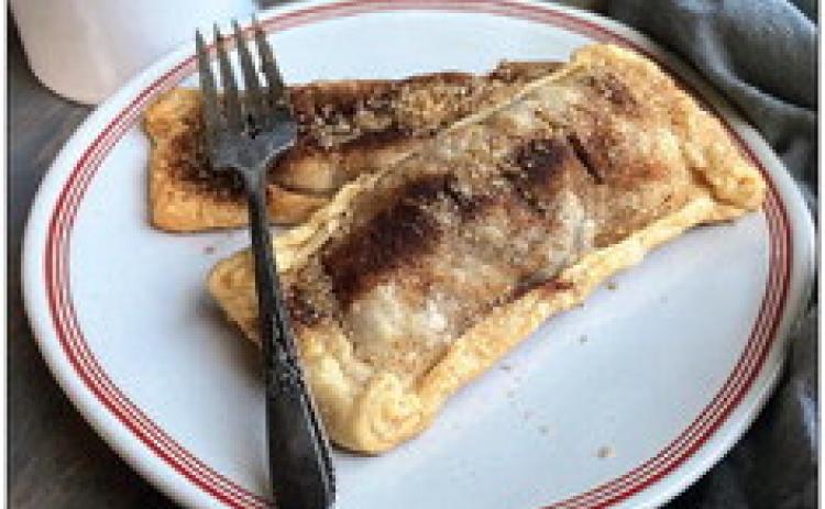 BAKED, NOT DEEP-FRIED A flaky crust filled with crisp apples and chewy dates is a winning combination for a hand pie, topped with cinnamon and crunchy turbinado sugar. | ANGELINA LARUE photo