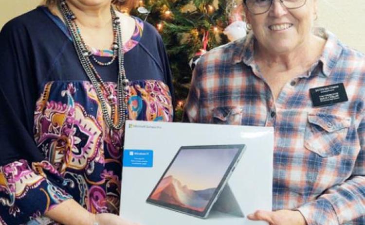 GRAND PRIZE Paducah Chamber of Commerce president Delisa Piper (left) presents Lesa Saltzman of the Triangle Ranch with the grand prize, a Microsoft Surface Pro, in the Paducah Chamber of Commerce 25 Days of Christmas. | COURTESY PHOTO