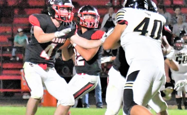 BLOCKING BACK In Friday night’s Motley County victory over Crowell, running back Jake Richards rushed for 160 yards and 3 touchdowns, as well as leading defensively with four tackles and four assists. Shown here is Richards blocking the Crowell defensive rush and protecting the quarterback. | COURTNEY MENDOLA PHOTO