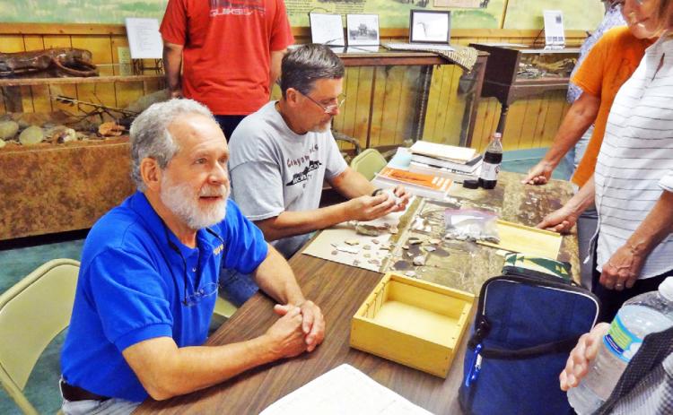 ARCHEOLOGISTS, HISTORIANS TO GATHER Paul Katz and Rick Day evaluate collections brought in for identification and analysis at a previous gathering at Comanchero Canyons Museum in Quitaque. | KAYLA WHITE PHOTO