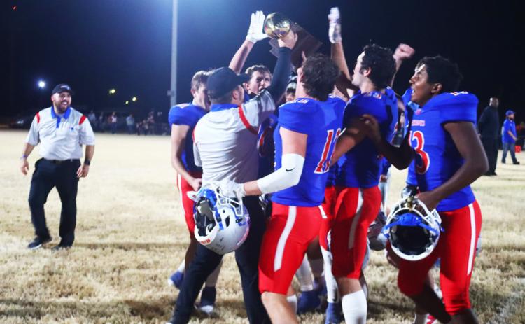 GOLD BALL CHASIN’ Valley’s homegrown head coach Dax Allen carries his first gold ball as a head football coach to his team following their bi-district blowout against the Northside Indians last Friday night. | VALLEY YEARBOOK
