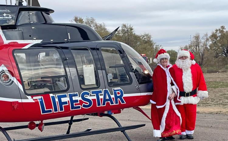 SANTA AND HIS BELOVED posed for a photo Saturday evening with the LifeStar 4 helicopter, operated out of Childress, Texas.