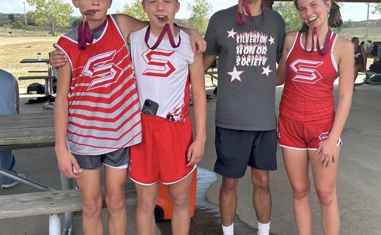 GREENBELT MEDALISTS Four Silverton Owls (from left), Corbin Hall, Briggs Holt, Haygen Lopez and Melody Rampley, placed in the top ten, earning medals at the Clarendon Lake Greenbelt Run cross country meet on Tuesday, Sept. 16. | COURTESY PHOTO