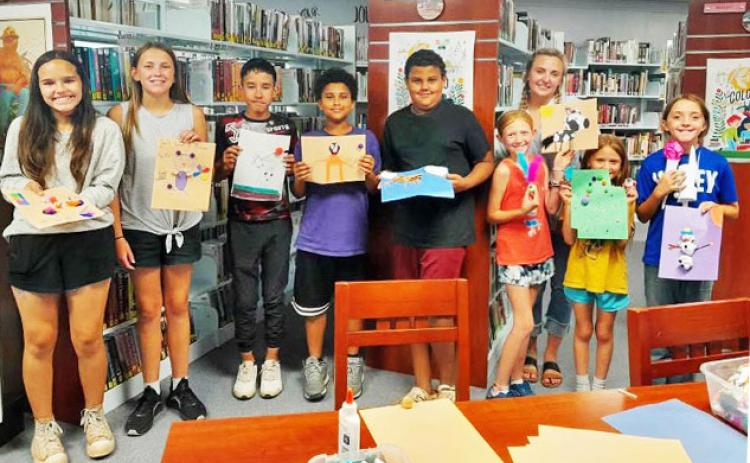 EXTENSION AGENT STEPHANIE OTIS (back right) was invited to lead a Summer Reading Program at Caprock Public Library during which the youngsters created food art. | COURTESY PHOTO