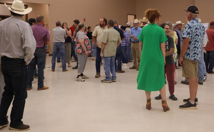 A FAIR SHAKE AT NEW CAREERS Community members gather and converse during the QTS job fair held at Valley School in Turkey.