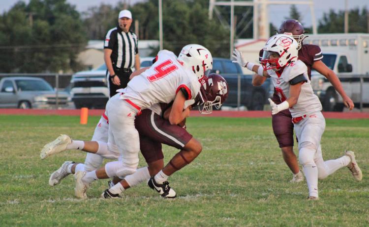 OWLDEFENSIVEFLOCK OwlCooperMullinsbringsdownaBooker Kiowa with the help of two team mates, Lucas Holt and Haygen Lopez on Thursday night, Sept. 18. | COURTESY PHOTO